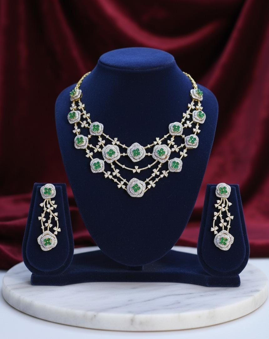 Jewelry set with necklace and earrings on a blue stand against a red fabric background