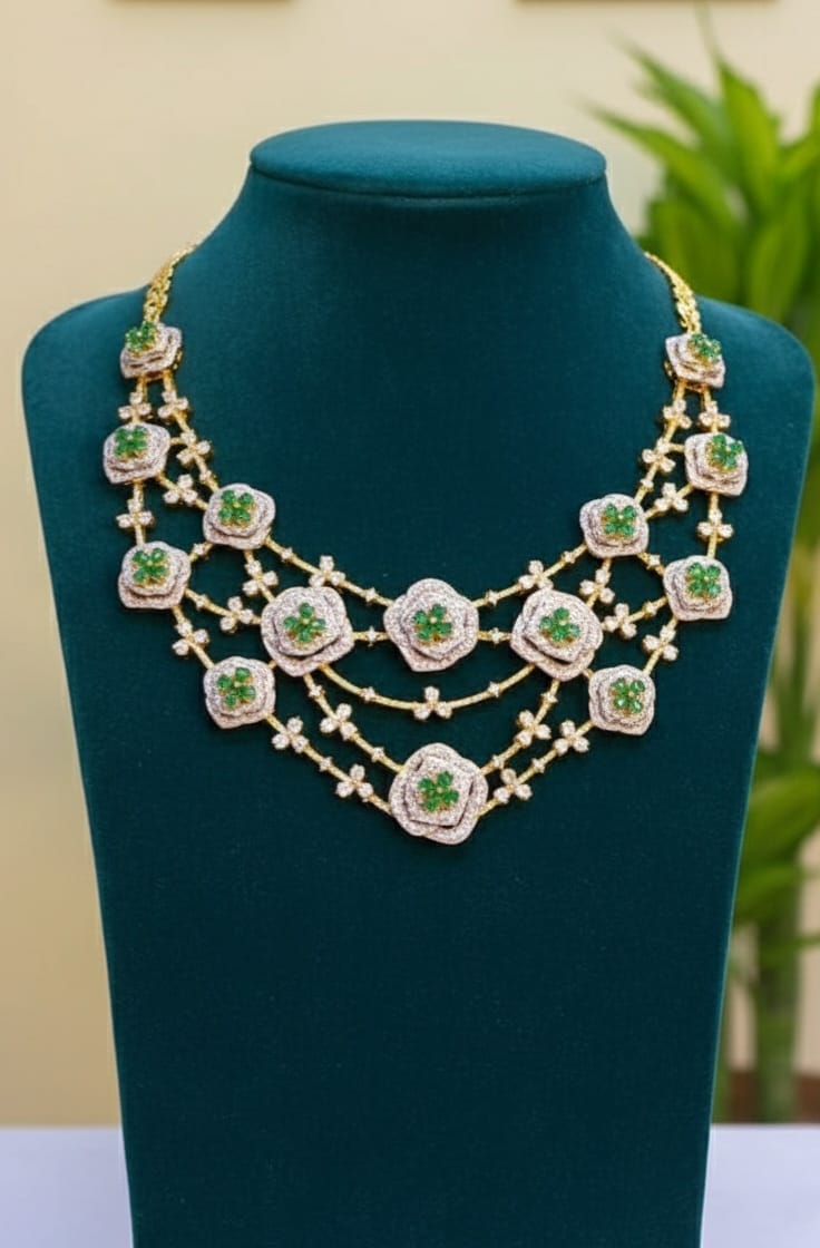 Elegant necklace with green gemstones on a green mannequin bust.
