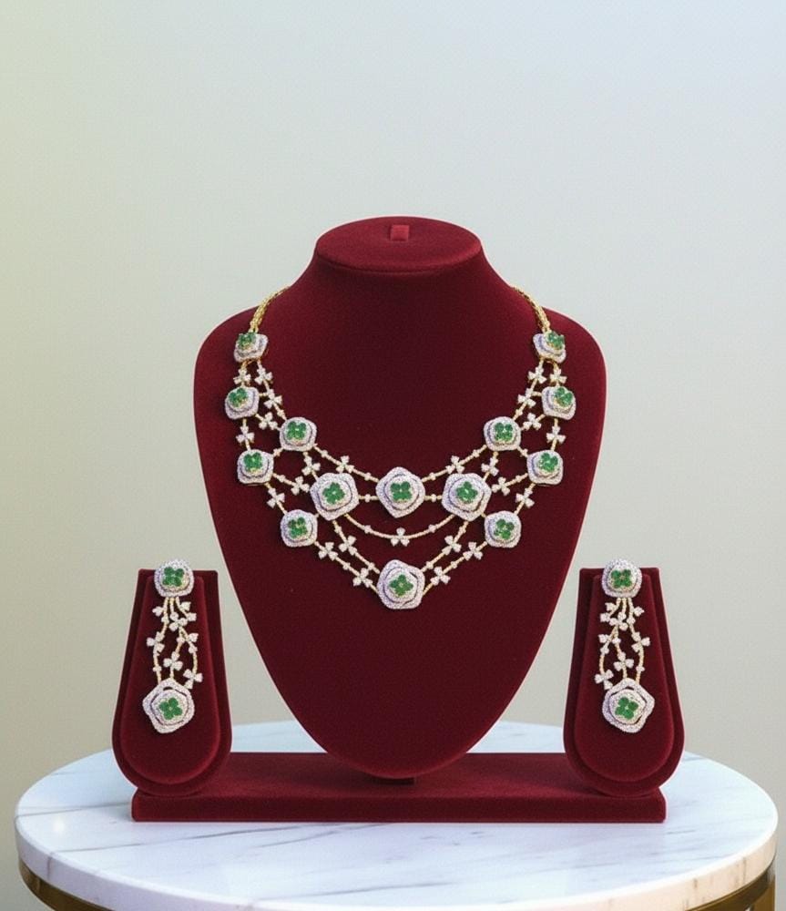 Jewelry set with necklace and earrings on a red velvet stand against a light background