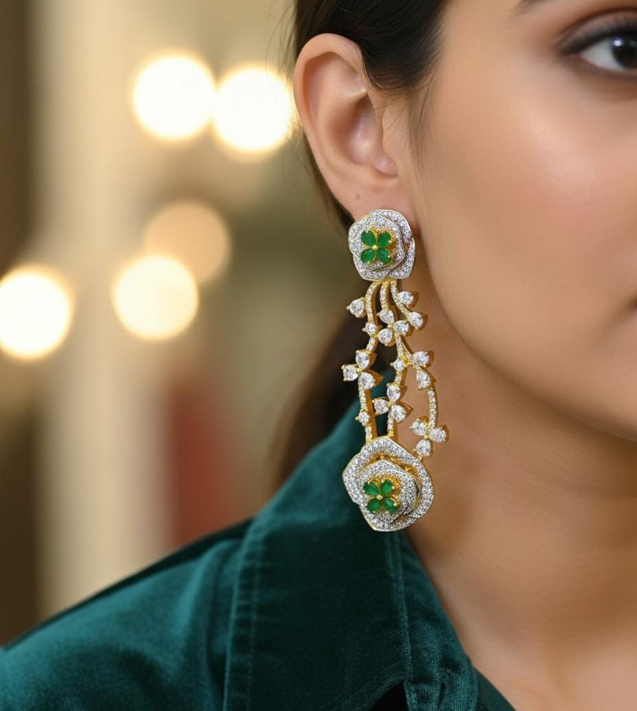 Close-up of a woman wearing a decorative earring with green gemstones against a blurred background.