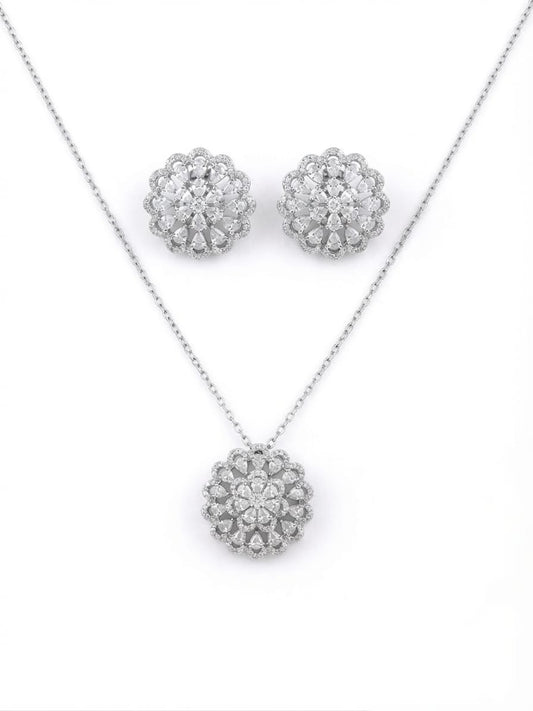 Silver-tone jewelry set featuring a necklace and matching stud earrings, each with a round floral cluster design set with clear stones on a white background.
