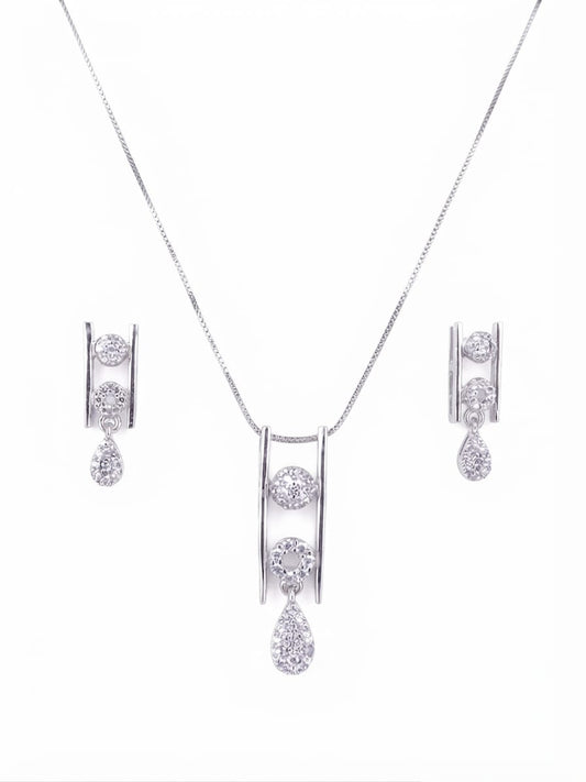 Silver-tone jewelry set featuring a necklace with a double-bar pendant and matching drop earrings, each adorned with clear gemstones, on a plain white background.
