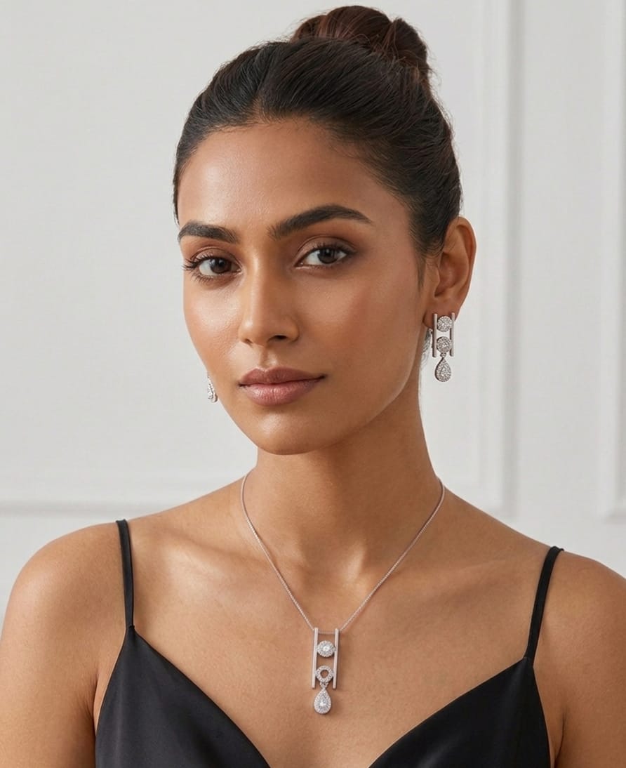 Woman wearing a necklace and earrings against a plain background