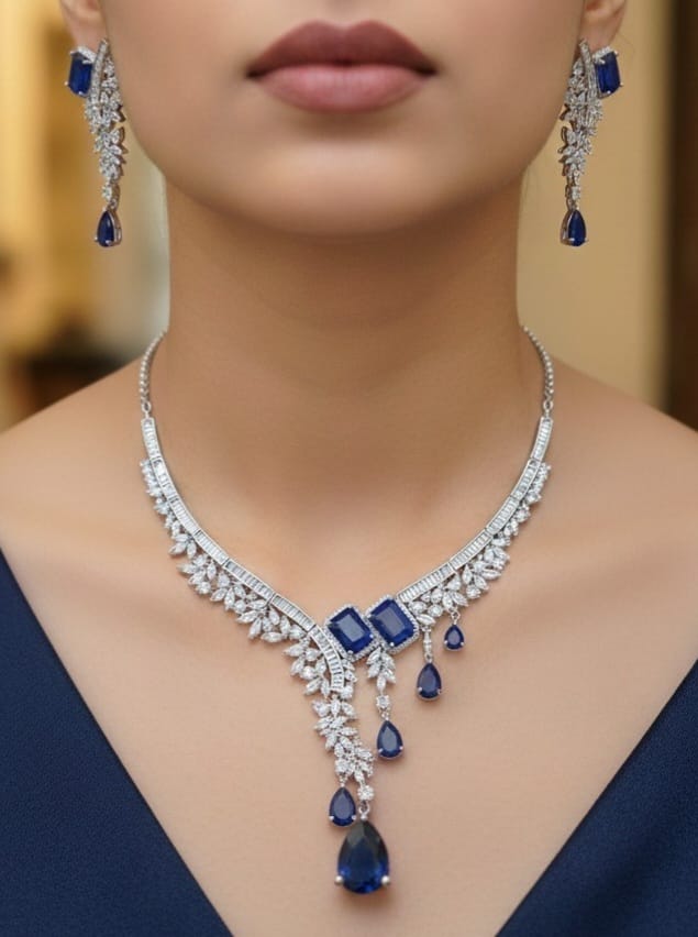 Close-up of a person wearing a blue and silver jewelry set with a blurred background